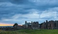 Heavy sky at Sunset over Lindisfarne Priory, Holy Island. Royalty Free Stock Photo
