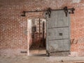 Heavy sliding metal industrial door in old warehouse