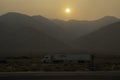 Smoke at sunset obscures the huge eastern escarpment of the Sierra N Royalty Free Stock Photo