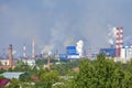 Heavy smoke industrial chimneys causing air pollution problems. Emissions are visible over residential areas of the city. Royalty Free Stock Photo