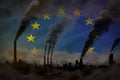 Heavy smoke of industrial pipes on European Union flag - global warming concept, background with space for your logo - industrial