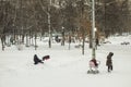 In heavy snow woman and two children playing near a block of fla Royalty Free Stock Photo