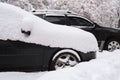 Heavy snowfall in the city and cars in the snow