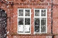 Heavy snowfall on a city street in the winter in Manchester Levenshulme England. White windows, typical English red bricks house. Royalty Free Stock Photo