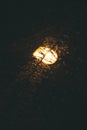 during heavy snowfall in winter, lanterns shine in the park. evening lighting