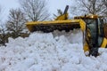 After heavy snowfalls, snowstorm snowplow trucks remove a snow from parking lot