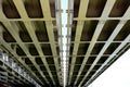 Heavy steel girders of span bridge. underside view. Royalty Free Stock Photo