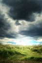 Heavy storm clouds over a green grass field Royalty Free Stock Photo