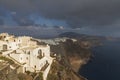 Heavy storm clouds with rainbow over Megalochori on Santorini island Royalty Free Stock Photo