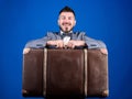 Heavy suitcase. Delivery service. Travel and baggage concept. Hipster traveler with baggage. Baggage insurance. Man well Royalty Free Stock Photo