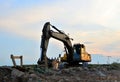 Heavy tracked excavator at a construction site on a background of a residential building Royalty Free Stock Photo