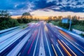 Heavy traffic moving at speed on UK motorway in England at sunset