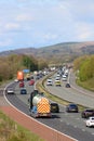 Heavy traffic three lane motorway in countryside Royalty Free Stock Photo