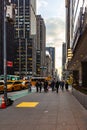 People walking on sidewalk with heavy traffic on a busy street in New York City USA Royalty Free Stock Photo