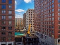 Heavy truck crane on a construction site between high-rise buildings. Royalty Free Stock Photo