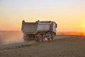 Heavy truck in dusty sunset
