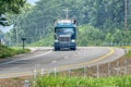 Heavy Truck Negotiates Curve On Rural Blacktop Road