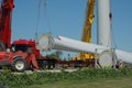 Heavy truck with rotor blade for wind turbine is unloaded by 2 cranes