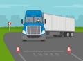 Heavy vehicle driving practice test with red cones. Student driver sitting in a blue truck and making a left turn.