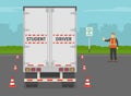 Heavy vehicle driving practice test with red cones. Student driver driving a truck. Instructor makes a stop gesture with his hand. Royalty Free Stock Photo