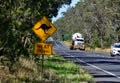 Heavy vehicle on a rural Victorian road, transporting a large tank. Royalty Free Stock Photo