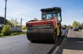 Heavy Vibration roller at asphalt pavement working on the new road construction site. Repairing.