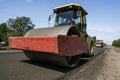 Heavy Vibration roller at asphalt pavement working on the new road construction site. Repairing.