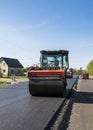 Heavy Vibration roller at asphalt pavement working on the new road construction site. Repairing.