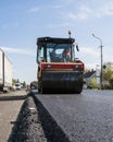 Heavy Vibration roller at asphalt pavement working on the new road construction site. Repairing.