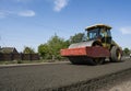 Heavy Vibration roller at asphalt pavement working on the new road construction site. Repairing.