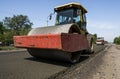 Heavy Vibration roller at asphalt pavement working on the new road construction site. Repairing.