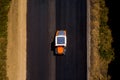 Heavy Vibration roller at work paving asphalt, road repairing. road roller flattening new asphalt. Aerial view Royalty Free Stock Photo