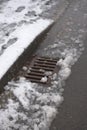 7 - Heavy water run off into a surface kerbside drain from snowfall