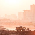 Heavy wheel excavator machine working at sunset Royalty Free Stock Photo