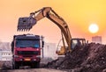 Heavy wheel excavator machine working at sunset Royalty Free Stock Photo