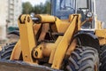 Heavy wheel loader with a bucket at a construction site. Equipment for earthworks, transportation and loading of bulk materials -