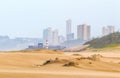 Heavy Wind Blowing Sand on Beach Against City Skyline Royalty Free Stock Photo