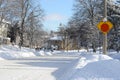 Heavy winter snow fall in a Canadian city street in residential area with roads cleared from snow