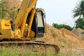 Heavy yellow excavators moving to the parking.