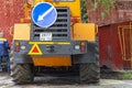 A heavy yellow road excavator on the road in the city. Moscow, Russia