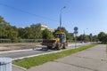 A heavy yellow road excavator on the road in the city. Moscow, Russia