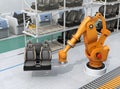 Heavyweight robotic arm carrying car seats in car assembly production line Royalty Free Stock Photo