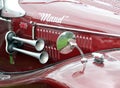 Detail of a red old sports car with mirror, horn and the nickname maude Royalty Free Stock Photo