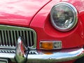 Close up of the front of a classic red british mgb sports car showing headlamp and chrome bumper at the Annual Hebden Bridge Vinta Royalty Free Stock Photo