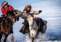 Mongolian cowboy in traditional costumes riding wild horses on the ice