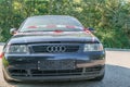 Close up of an Audi A3 after an accident with police barrier tape with German word for police barricade, Germany