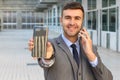 Hectic businessman multitasking with two smartphones