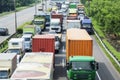 Hectic traffic in a tollway with long row of trucks