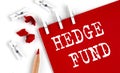 HEDGE FUND text on red paper with office tools on white background Royalty Free Stock Photo