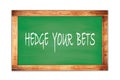 HEDGE YOUR BETS text written on green school board